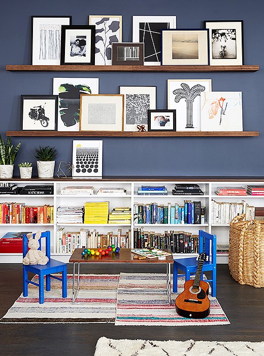 A pair of shallow shelves offer up a casual way to show off your art collection. Photo by Manuel Rodriguez.
